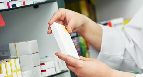 Pharmacist holding a box of medication