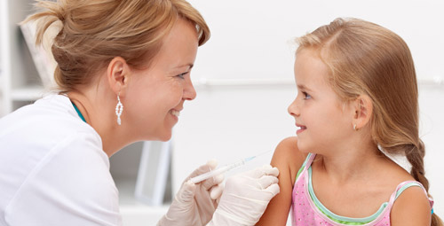 Doctor giving a young girl an injection